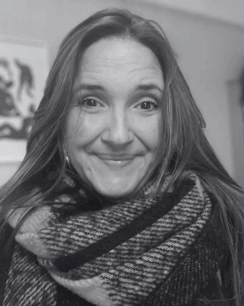 woman smiling with a scarf on